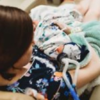 raiven adams holds newborn river anthony