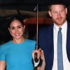 meghan markle and prince harry under an umbrella