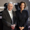 French Greek screenwriter and director Costa Gavras L and UNESCO General director Audrey Azoulay pose during a photocall at the opening of the exhibition CineMode par Jean Paul by French fashion d